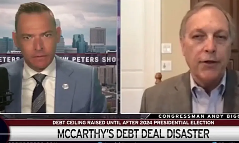 Image is taken from video of the Stew Peters show. It is a split-screen image with host Stew Peters on the left and Rep. Andy Biggs on the right. Text below them reads "McCarthy's Debt Deal Disaster."