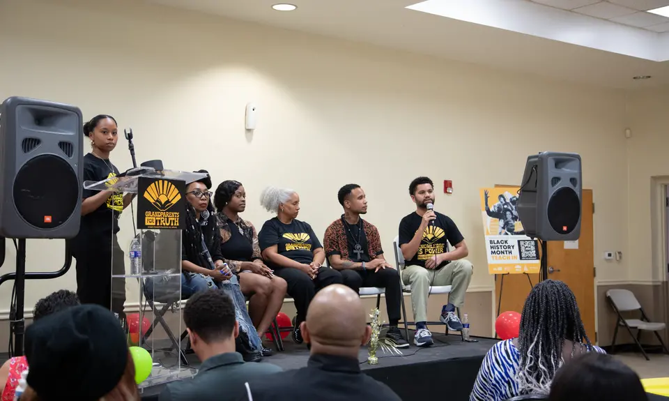 Speakers gather on stage to discuss the importance of teaching Black history