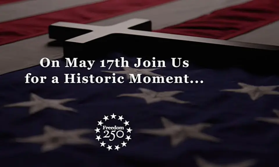 Image from Freedom 250 promotional video shows a cross laying across an American flag with the text, "On May 17th Join Us for a Historic Moment..." The image includes the logo for Freedom 250.