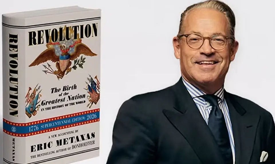 The left side of the image is a photograph of Eric Metaxas' book "Revolution." The ride side is a chest-and-head portrait of Metaxas in suit and tie smiling for the camera. 