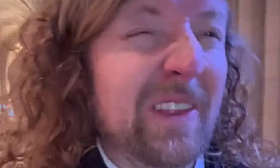 Sean Feucht with face in a grimace from within Washington National Cathedral