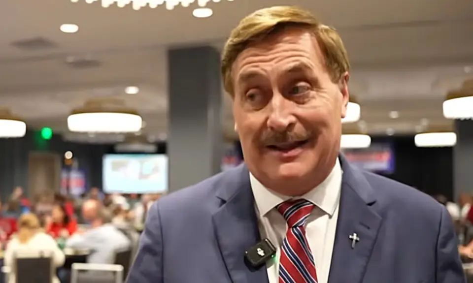 Mike Lindell, in suit and tie, is speaking to a reporter from his Aug. 11, 2026 election watch party.