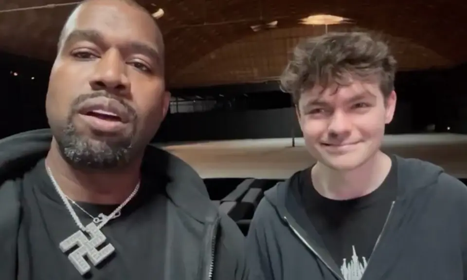 Nick Fuentes With Kanye West, who is wearing a large swastika necklace
