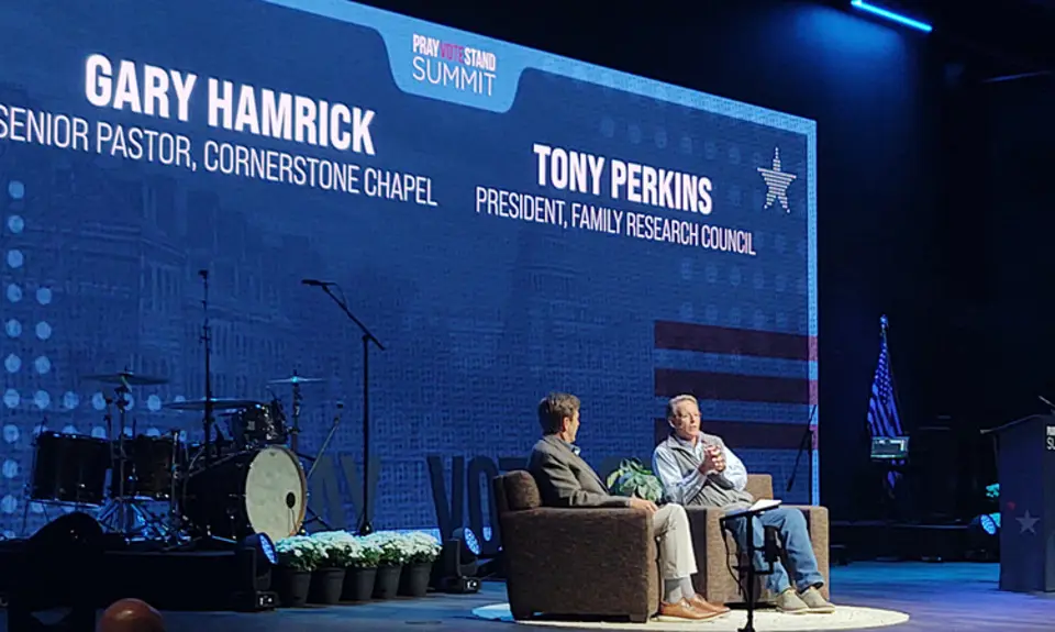 Cornerstone Chapel pastor Gary Hamrick and FRC President Tony Perkins sit on stage at the 2026 Pray Vote Stand summit with their names and IDs projected on the backdrop behind them.