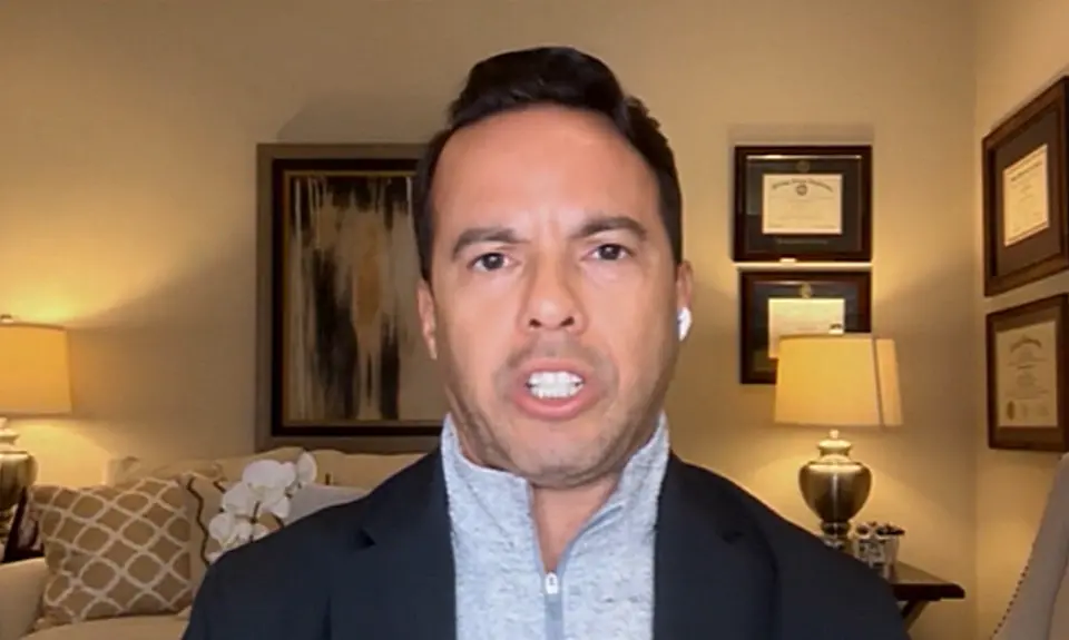 Samuel Rodriguez speaking into the camera in what appears to be a living room or home office setting.