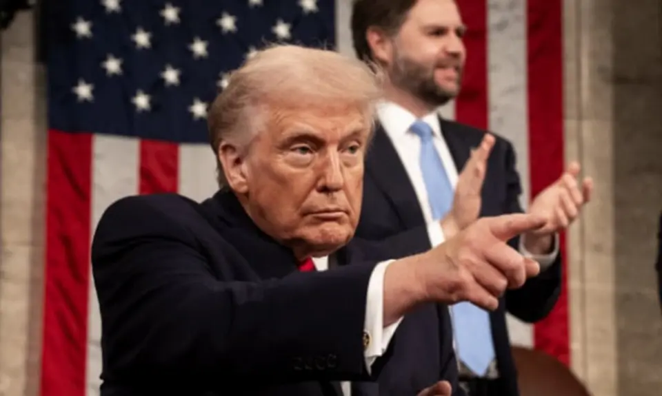 Image of Trump at State of the Union pointing toward audience, with VP JD Vance visible standing behind him and applauding