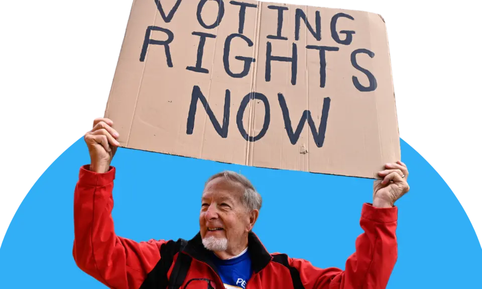 Man holding a sign that reads "voting rights now" 