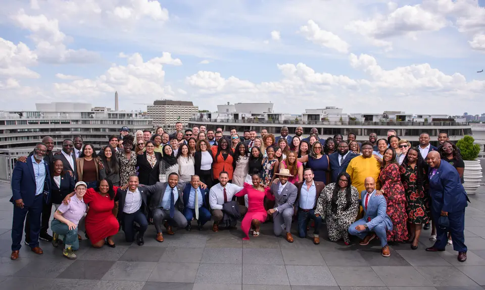 A group of Young Elected Officials posing on the roof of a building.