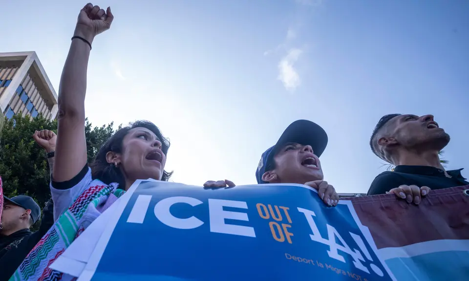 People in Los Angeles hold a sign that says "Ice out of LA"