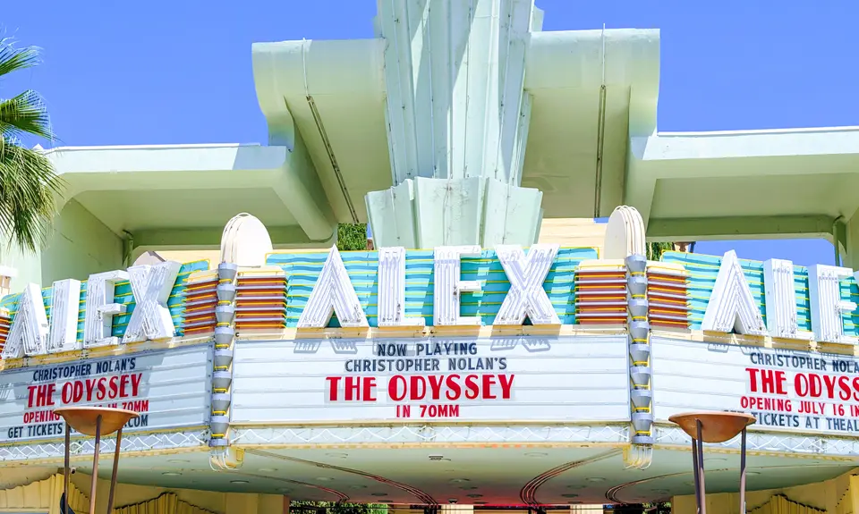 The marque of a movie theater called the Alex Theater showing Christopher Nolan's The Odyssey. 