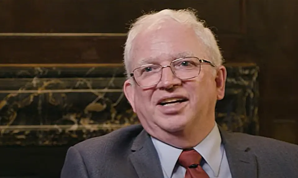 Image of John Eastman, white-haired white man in suit and tie.
