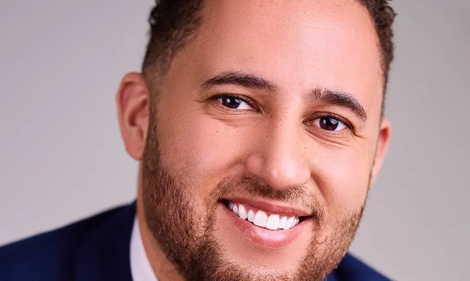 Headshot of Svante Myrick wearing dark blue suit.