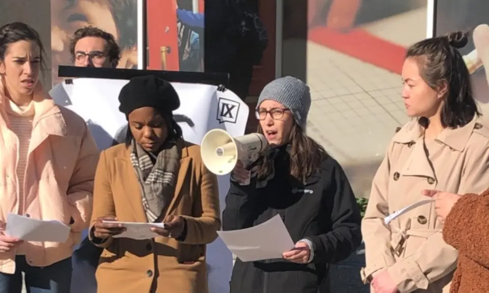 A woman speaks into a megaphone