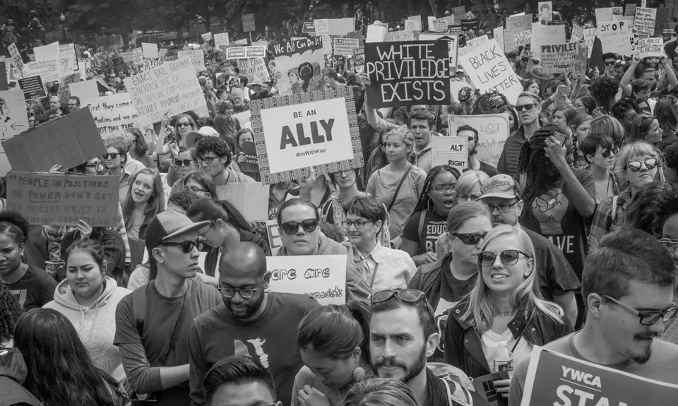 Activists carry signs at the March for Racial Justice