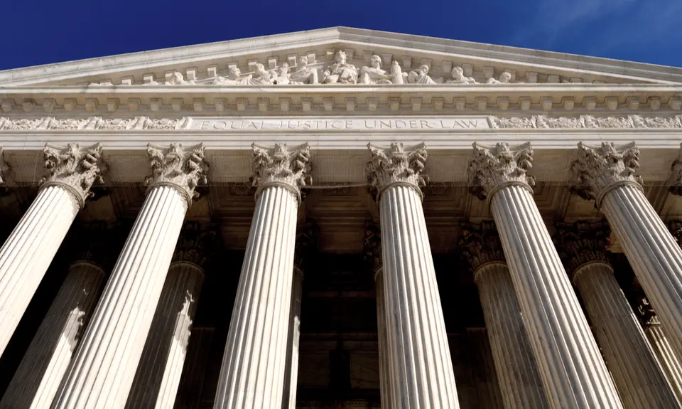 An image of the facade of the Supreme Court Building taken from below.