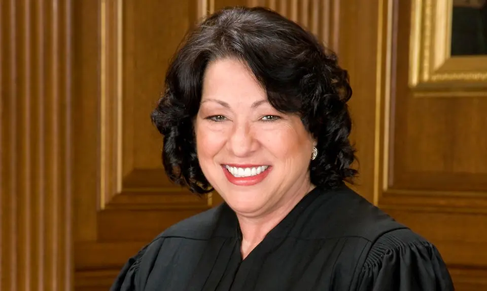 Supreme Court Justice Sonia Sotomayor wearing her black robe and smiling
