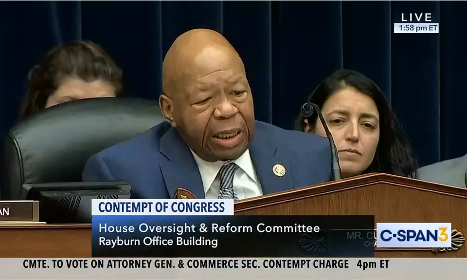 Elijah Cummings sits behind a podium during a committee meeting.