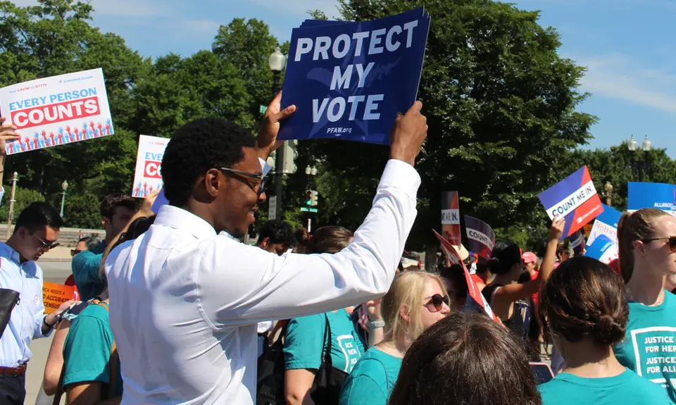 Activists hold signs that say "Every person counts" and "Protect my Vote"