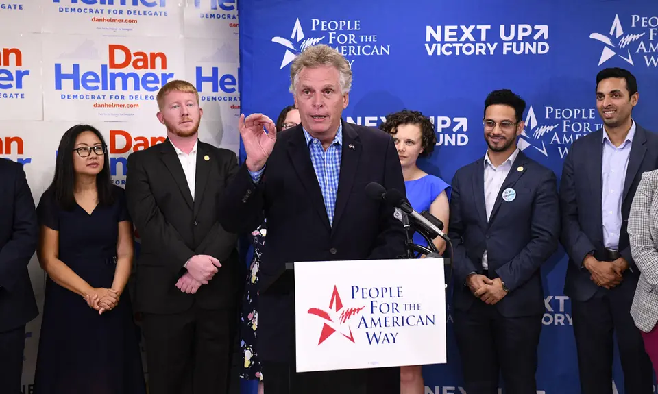 Former VA Gov. Terry McAuliffe at the speaker's podium at PFAW's Next Up 2019 Virginia kickoff event.