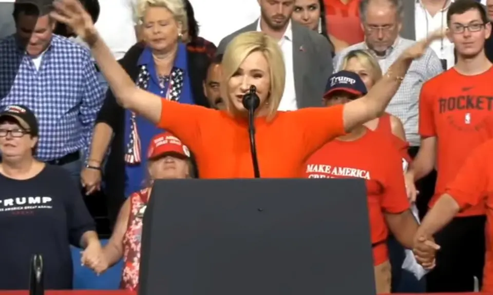 Paula White prays at a Trump rally.