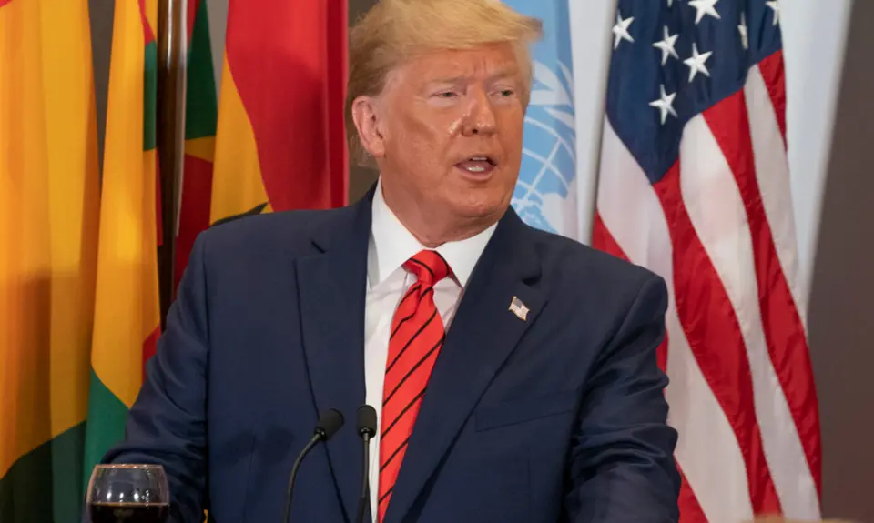 Donald Trump stands at a podium