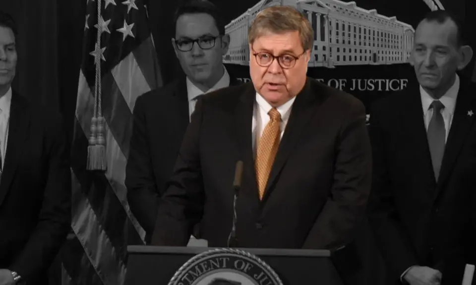 William Barr speaking at a podium