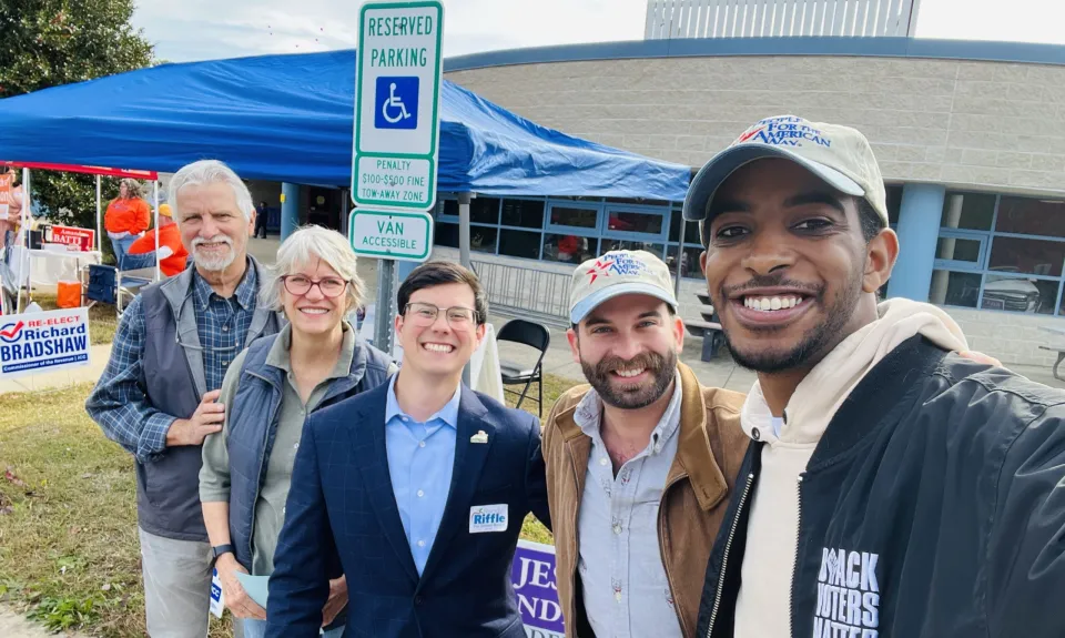 Markus Batchelor and Josh San Miguel posing outdoors with Randy Riffle and two others.