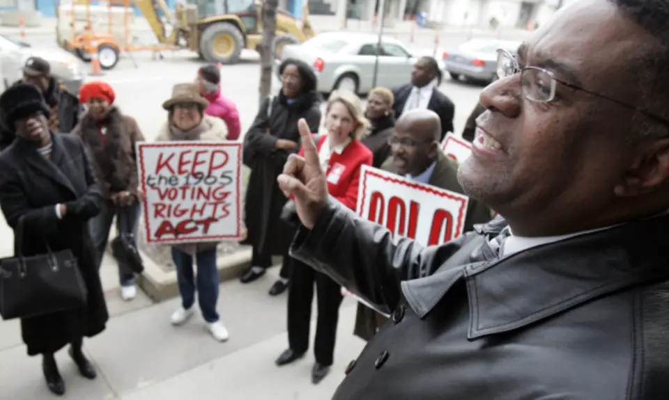 Dr. Tony Minor, right, speaks before a march Tuesday, April 4, 2006 in Cleveland. (AP Photo/Tony Dejak)