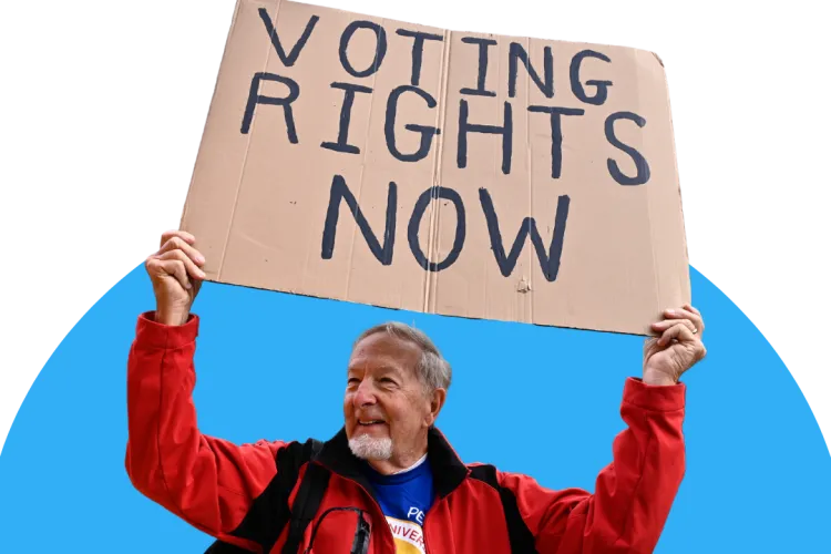 Man holding a sign that reads "voting rights now" 