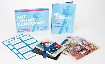 A collection of items from the Art of Saving Democracy, including book, stickers and posters