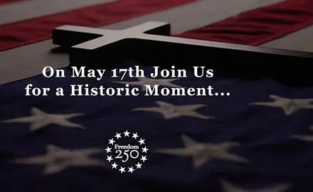 Image from Freedom 250 promotional video shows a cross laying across an American flag with the text, "On May 17th Join Us for a Historic Moment..." The image includes the logo for Freedom 250.