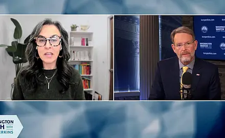 Split-screen image from "Washington Watch with Tony Perkins." Katy Fausst, a white woman with long black and gray hair, is seated at the left in what looks like a home office; FRC President Tony Perkins is on the right in a studio setting with FRC logos visible behind him. 