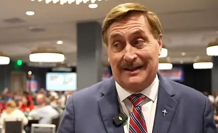 Mike Lindell, in suit and tie, is speaking to a reporter from his Aug. 11, 2026 election watch party.
