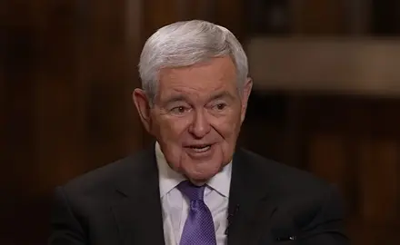 Newt Gingrich, an older white man with gray hair and wearing suit and tie, is speaking while looking toward Sean Hannity who is off camera at this moment.
