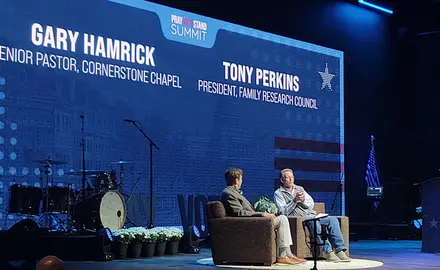 Cornerstone Chapel pastor Gary Hamrick and FRC President Tony Perkins sit on stage at the 2026 Pray Vote Stand summit with their names and IDs projected on the backdrop behind them.