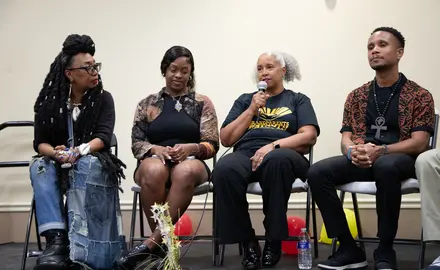 Speakers gather on stage to discuss the importance of teaching Black history