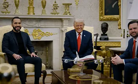 Photo shows US President Donald Trump and President Bukele of El Salvador smiling while seated together in the Oval Office with VP J.D. Vance seated to the side.