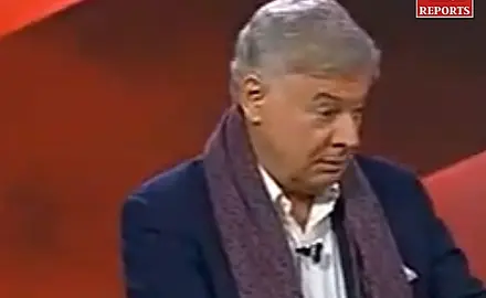 Lance Wallnau on set of Flashpoint wearing blue blazer with a purple scarf around his neck