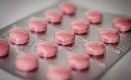 a packet of round, pink pills.