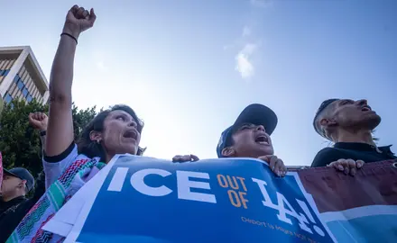People in Los Angeles hold a sign that says "Ice out of LA"