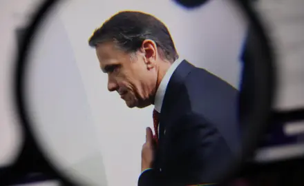 A photo of Todd Blanche with a graphic of a magnifying glass around the photo. 