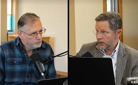 Split screen shows Kevin Swanson on the left, Raymond Simmons on the right, both seated in what appear to be modern church buildings. Swanson is speaking into a microphone and Simmonds has a laptop open in front of him. 