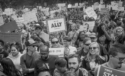 Activists carry signs at the March for Racial Justice