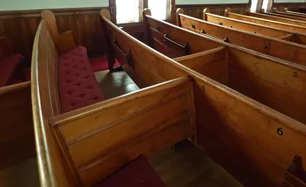 Church pews with dividers in the middle of each row