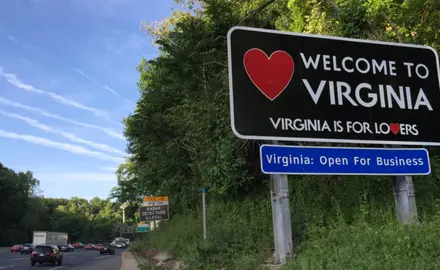 A highway sign reading "Welcome to Virginia, Virginia is for lovers."