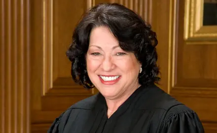 Supreme Court Justice Sonia Sotomayor wearing her black robe and smiling