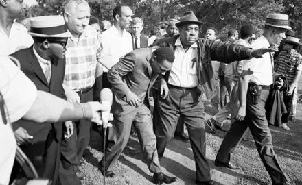 Civil rights protesters, including Martin Luther King, Jr., march toward a realtor's office in 1966