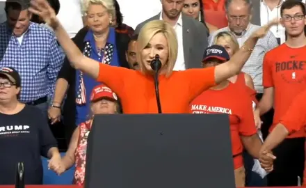 Paula White prays at a Trump rally.