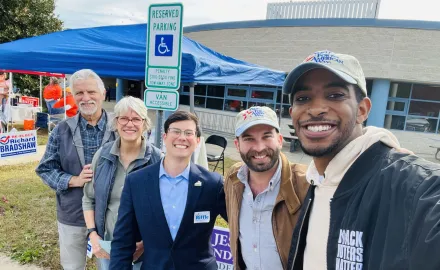 Markus Batchelor and Josh San Miguel posing outdoors with Randy Riffle and two others.