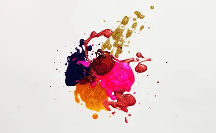 blobs of brightly colored paint on a white surface